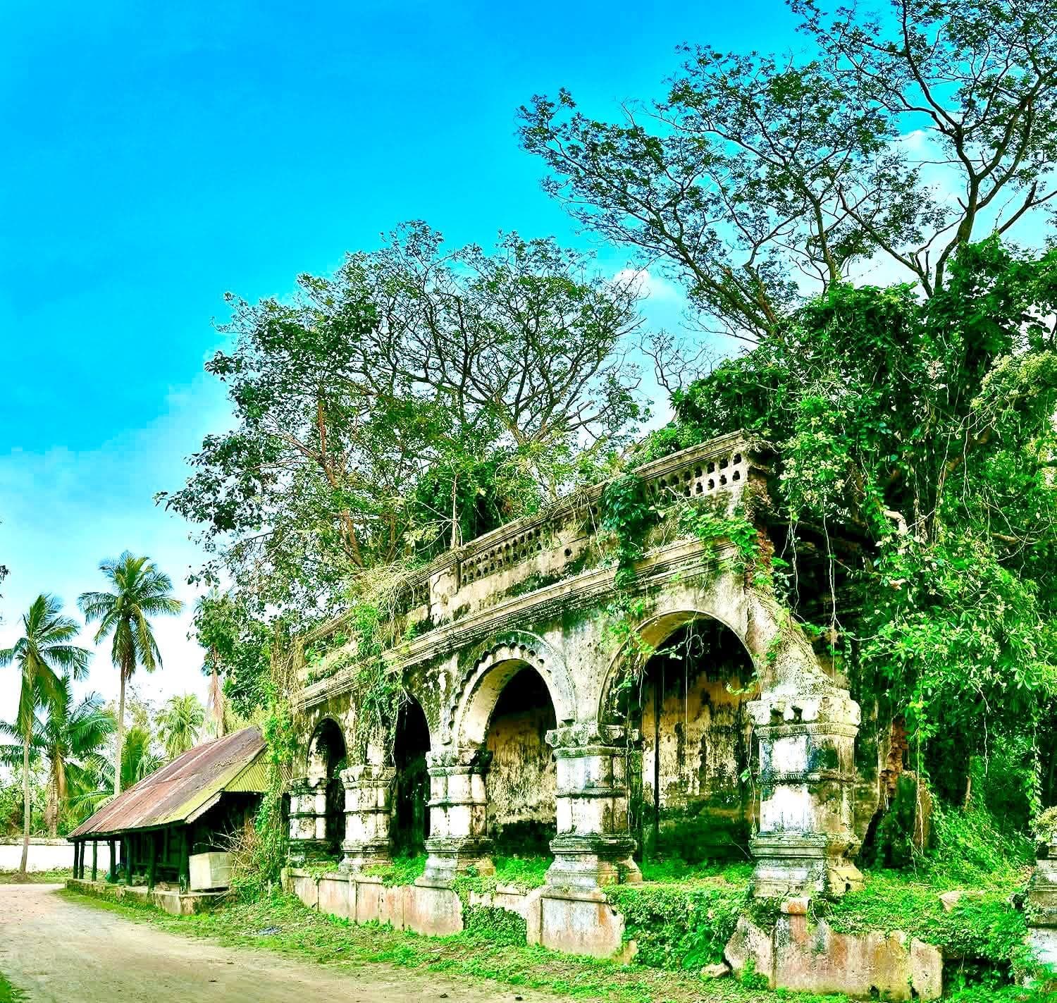 An old arched pavilion surrounded by greenery